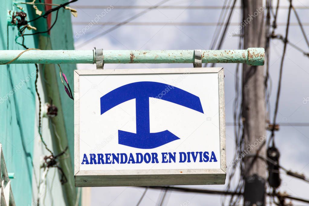 Sign 'Arrendador en Divisa' at Casa Particular (private homestay) for foreigners in Cuba. Homestays for Cubans have different color.