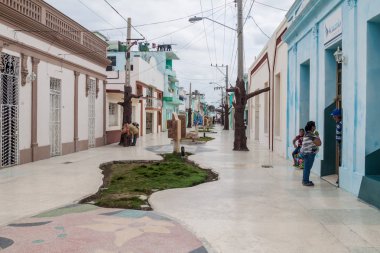 BAYAMO,  CUBA - JAN 30, 2016: Pedestrian zone at General Garcia street in Bayamo. clipart