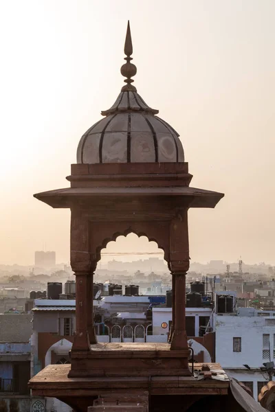Small tower of Jama Masjid mosque in the center of Delhi during sunset, India.
