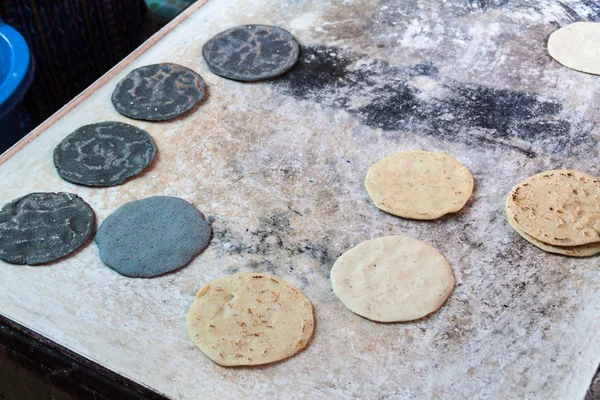 Dark and light tortillas being prepared at the market in Santiago Atitlan village, Guatemala