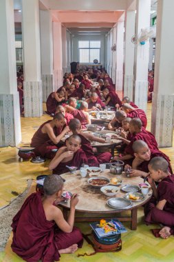 Bago, Myanmar - 10 Aralık 2016: Bago tapınağında rahipler Kya Kha Wain Kyaung onların öğle yemeği yemek.