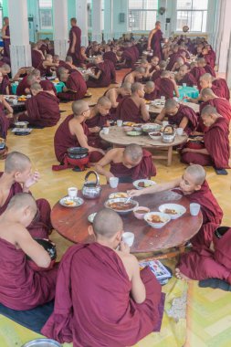 Bago, Myanmar - 10 Aralık 2016: Bago tapınağında rahipler Kya Kha Wain Kyaung onların öğle yemeği yemek.