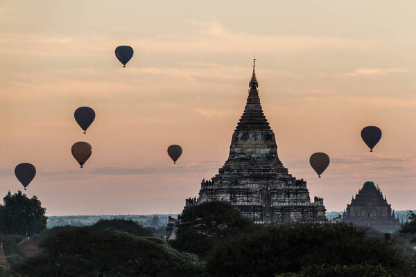 Balloons over Bagan and the skyline of its temples, Myanmar. Sulamani temple and Shwesandaw pagoda.