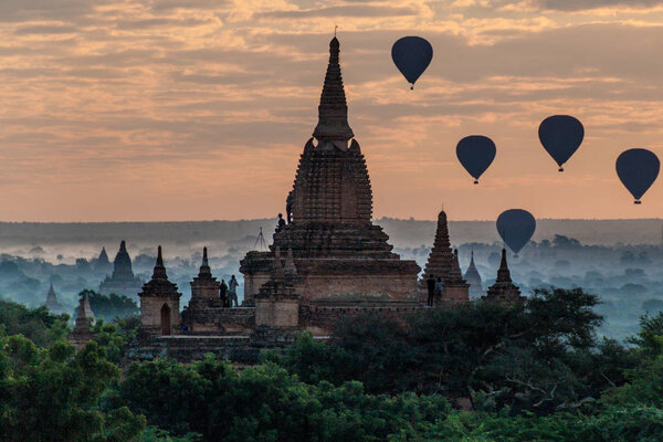 Balloons over Bagan and the skyline of its temples, Myanmar. Myauk Guni Temple.