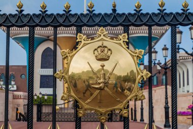 MUSCAT, OMAN - FEBRUARY 23, 2017: National emblem of Oman on the gate of Al Alam palace in Muscat, Oman