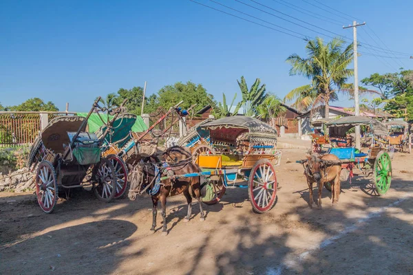 Horse carts waiting for tourists in ancient town Inwa (Ava) near Mandalay, Myanmar