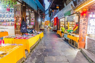 FURONG ZHEN, ÇİN - 11 Ağustos 2018: Furong Zhen kasabası, Hunan eyaleti, Çin 'de çeşitli tezgahları olan dar bir sokak manzarası