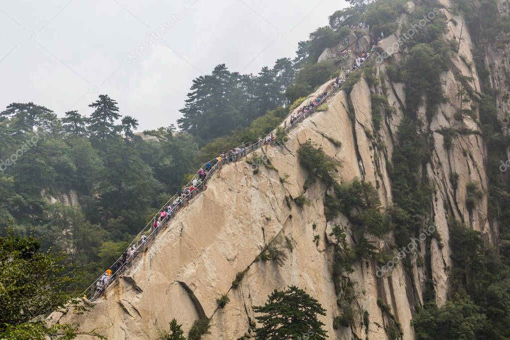 People climb at the stairs leading to the peaks of Hua Shan mountain in Shaanxi province, China