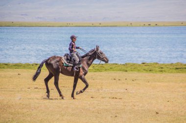 Song KOL, KYRGYZSTAN - 25 Temmuz 2018: Son Kol Gölü kıyılarındaki Ulusal At Oyunları Festivali 'nde ata binen çocuk