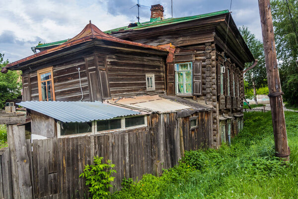 Typical old Russian wooden house in Tyumen city, Russia