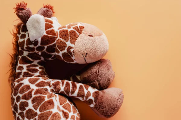 Giraffe soft toy and plush animal doll beige color background for kids