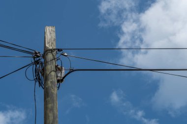 Ahşap sütun elektrik ve iletişim kabloları ve zincir ve bulutlar