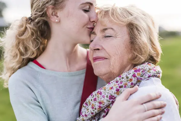 Granddaughter Kissing Her Grandmother — Stock Photo, Image