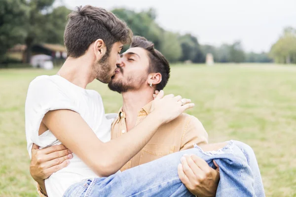 公園でリラックス若いゲイのカップルにキス — ストック写真