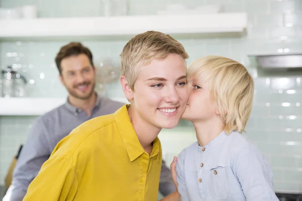 Son Kissing Mother Kitchen Father Background — Stock Photo, Image