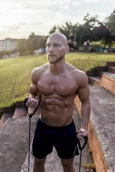 Barechested Muscular Man Exercising Expander Outdoors — Stock Photo, Image