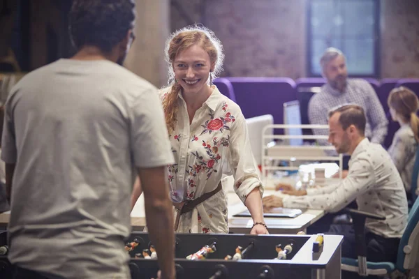 Business people in office taking a break, playing foosball — Stock Photo