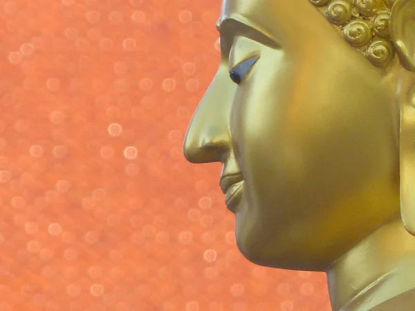 Face of gold Buddha close-up