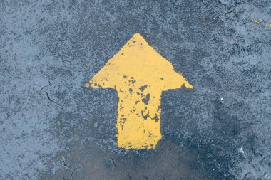 go straight yellow arrow on asphalt street