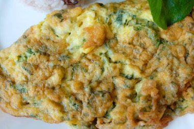 Mince pork omelet with rice on white dish