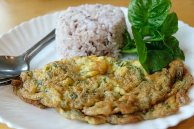 Mince pork omelet with rice on white dish