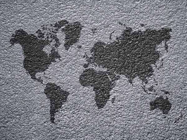 Mapa del mundo de color negro sobre fondo de pared de hormigón — Foto de Stock