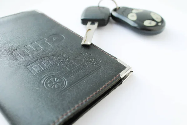 Car license and keys on a white background