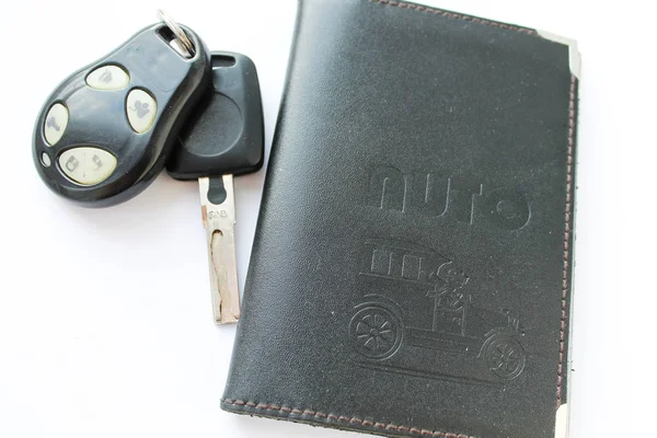 Car license and keys on a white background