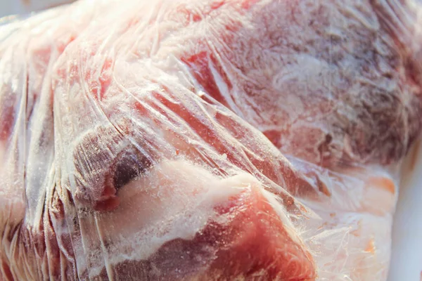 Frozen meat in a plastic bag.