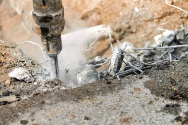 Beton inebilecek matkap kullanan çalışan adam jackhammer - yakın çekim 