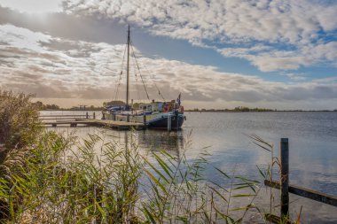 Netherlans - Terherne - 22 Ekim 2018: yatay, arka ışık içinde demirli tekneye Terherne, Friesland, Hollanda.