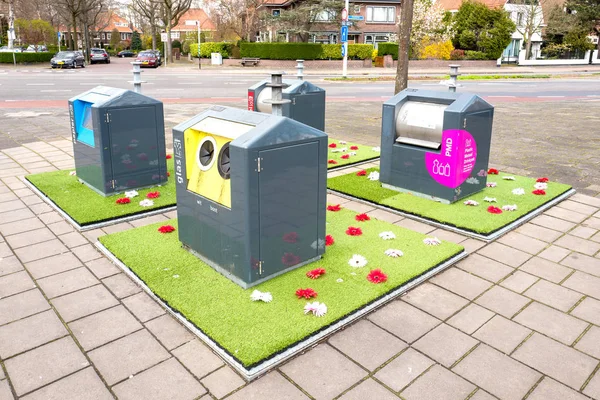 NETHERLANDS - VOORBURG - APRIL 3, 2019: Social garden experiment with plastic Oracs mini-yards around underground dirt containers to prevent waste from being put next to the container. — Stock Photo, Image