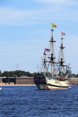 Russia, St. Petersburg, July 21, 2019, Frigate Poltava in the waters of the Neva and the Peter and Paul Fortress, preparing for the parade of the Navy. clipart