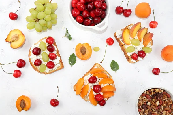 Diet fruit sandwiches with cottage cheese, peaches, grapes and cherries, a healthy breakfast with ingredients. The concept of a healthy and natural meal, lifestyle,