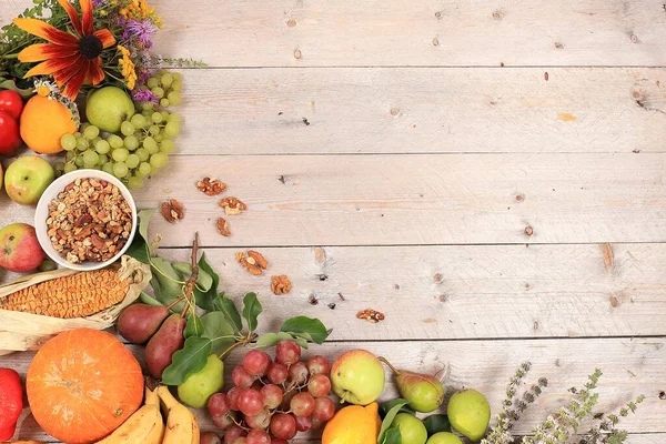 Autumn background with seasonal nature autumn berries, pumpkins, apples and flowers on wooden background, healthy natural food, vegan diet.Happy Thanksgiving concept, .