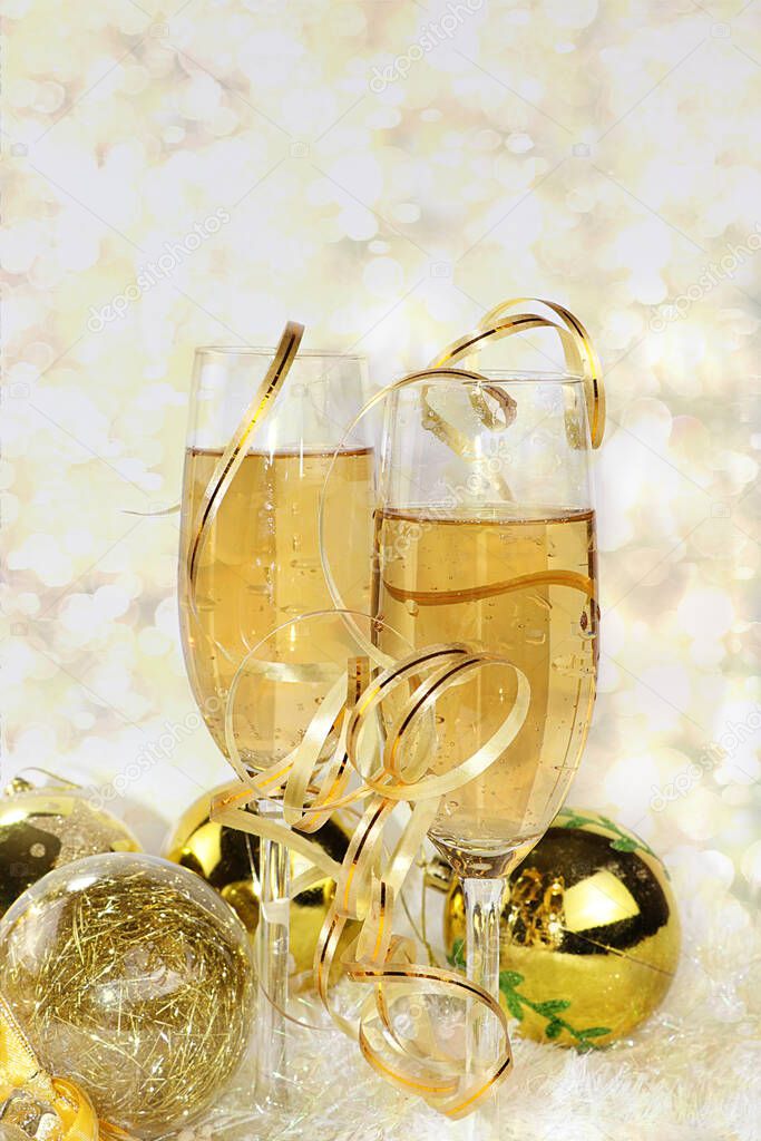 Champagne with bright ribbon and holiday decorations, Christmas and New Year background with bokeh lights, place for text. New Year card for congratulations, selective focus, banner for displaying or installing a product for promoting a holiday and a