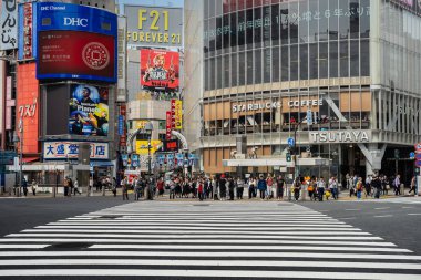 SHIBUYA, TOKYO, JAPAN - OCTOBER 16, 2018: Shibuya Crossing, One of the world's most used pedestrian scrambles, at Hachiko Square in Shibuya,  clipart