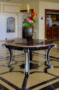 Sharm el-Sheikh, Mısır - 14 Mart 2018. Otel lobisinde Resepsiyon, mermer zemin, vitrinler, güzel bir taş masa ile iç kenarındaki çiçek dolu vazolar ile. Cyrene Grand otel konaklama