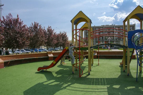 stock image Khust, Ukraine - April 22, 2018. Little children run around and play in the playground. Game center for a young child. Little girl is playing outdoors. The concept of summer children's entertainment.