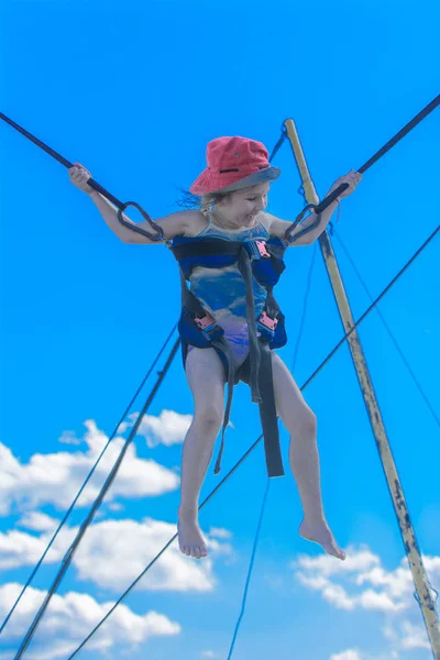 青空とゴムのロープでトランポリンでジャンプの子供 冒険と極端なスポーツ 夏のレクリエーション ジャンプの概念 — ストック写真