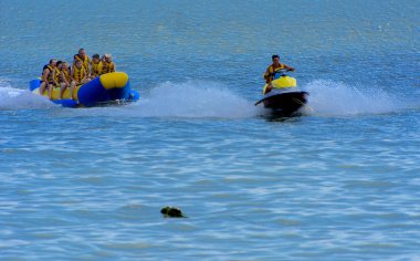 Odessa, Ukrayna - 8 Ağustos 2018. Turistler eğleniyor ve scooter deniz yoluyla taşıma kırmızı ve sarı şişme muz, binme keyfini çıkarın. Yaz tatili, tatil ve seyahat kavramı