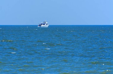 Odessa, Ukrayna - 08 Ağustos 2018. Açık denizde yürüyüşleri için mavi gökyüzü karşı yumuşak güneş ışığı akşam gemi. Yaz macera, tatil, etkin yaz tatil kavramı üzerinde Karadeniz, Ukrayna