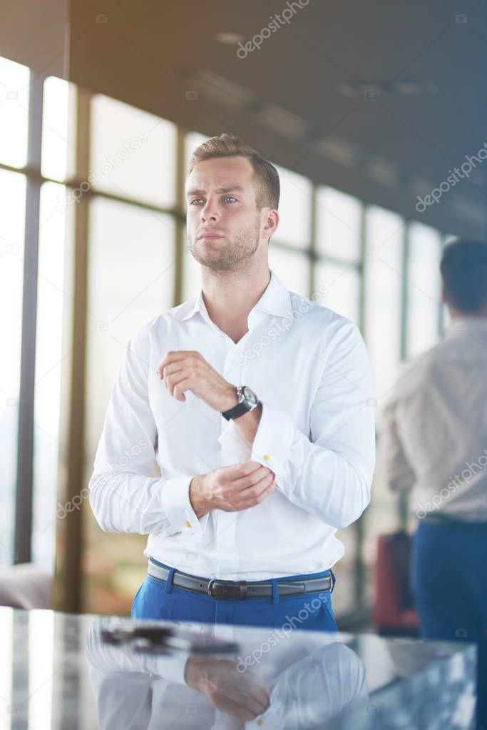 Like yourself. Confident young businessman looking in the mirror and fixing his shirt while being successful