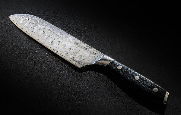 Knife with drops of water isolated on a black background
