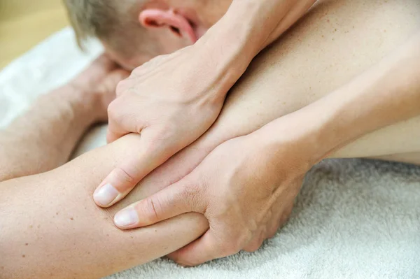 Health massage therapy. Female hands are massaging the man's arm.