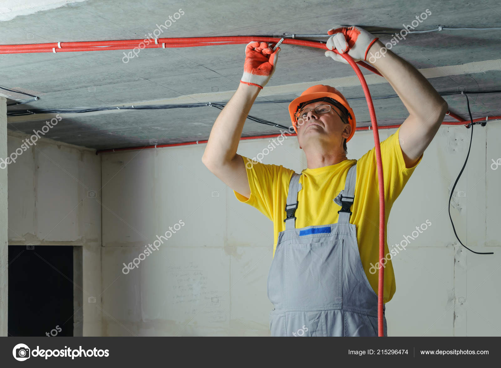 Electrician Fixing Electric Corrugated Tube Ceiling Stock Photo