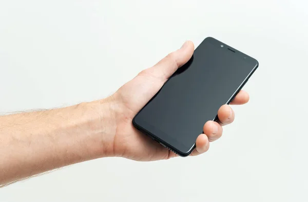 Human Hand Holding Black Smartphone White Background — Stock Photo, Image