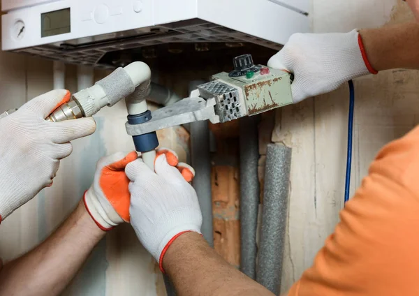 The workers is soldering  the gas boiler pipes. — Stock Photo, Image