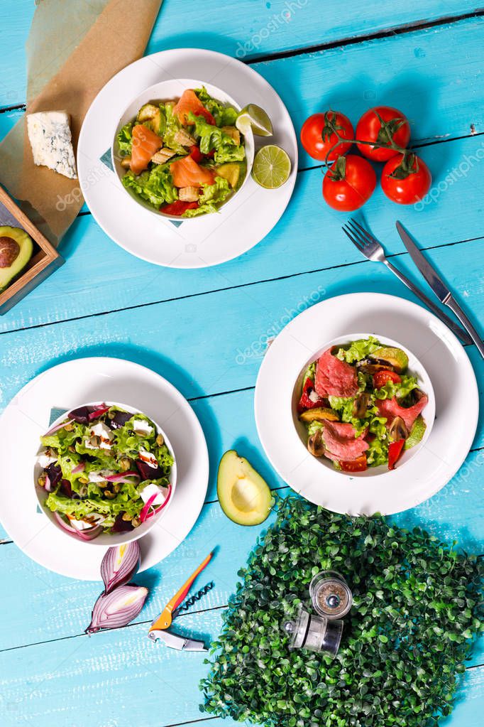 salad on a wooden blue table.ingredients for salon