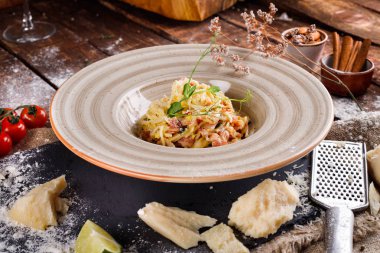 Parmesan peynirli makarna ve ahşap bir tabakta sos.